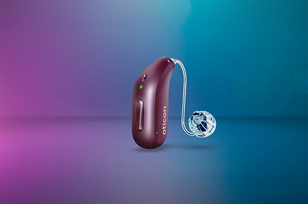 Oticon Reveal hearing aid in burgundy, shown against a blue and purple background
